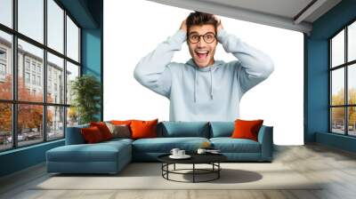 Young caucasian handsome man isolated screaming, very excited, passionate, satisfied with something. Wall mural