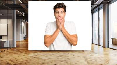 Young caucasian handsome man isolated shocked covering mouth with hands. Wall mural