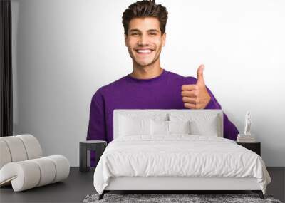 Young caucasian handsome man isolated smiling and raising thumb up Wall mural