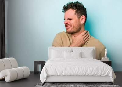 Young caucasian man isolated on blue background touching back of head, thinking and making a choice. Wall mural