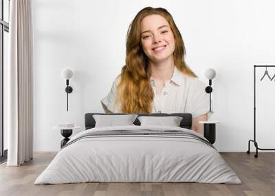 Young caucasian redhead woman isolated happy, smiling and cheerful. Wall mural