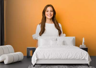 Young caucasian woman happy, smiling and cheerful. Wall mural