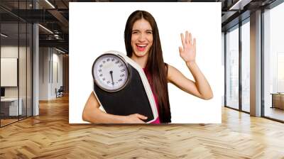 Young caucasian woman holding a scale isolated smiling cheerful showing number five with fingers. Wall mural