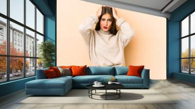 young caucasian woman isolated en beige background being shocked, she has remembered important meeti Wall mural