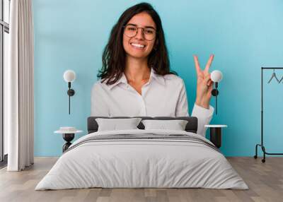 Young caucasian woman isolated on blue background showing number two with fingers. Wall mural