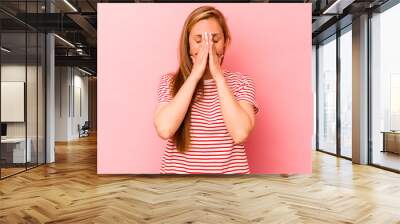 Young caucasian woman isolated on pink background holding hands in pray near mouth, feels confident. Wall mural