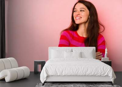 Young caucasian woman isolated on pink background smiling confident with crossed arms. Wall mural