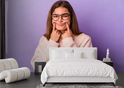 Young caucasian woman isolated on purple background doubting between two options. Wall mural