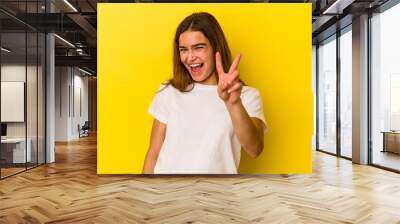 Young caucasian woman isolated on yellow background showing number two with fingers. Wall mural