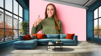 Young caucasian woman posing isolated  smiling and raising thumb up Wall mural