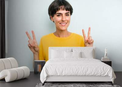 Young caucasian woman with a short hair cut isolated showing victory sign and smiling broadly. Wall mural