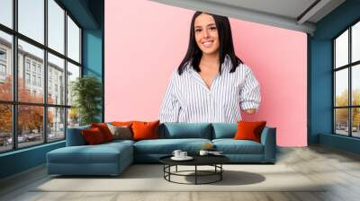 Young caucasian woman with one arm isolated on pink background happy, smiling and cheerful. Wall mural