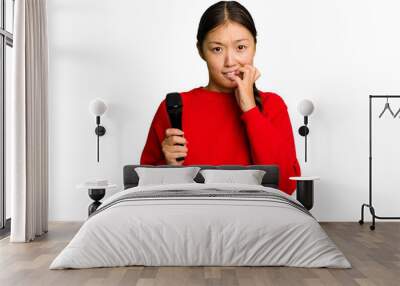 Young Chinese singer woman isolated biting fingernails, nervous and very anxious. Wall mural