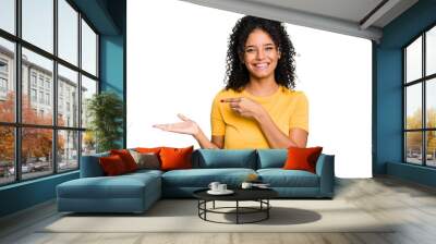 Young cute brazilian woman isolated excited holding a copy space on palm. Wall mural