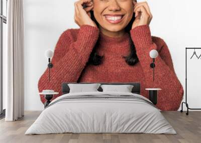 Young Filipina woman covering ears with hands. Wall mural