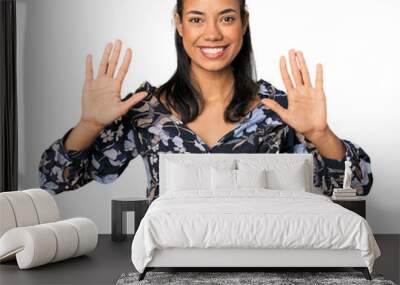 Young Filipino woman in studio showing number ten with hands. Wall mural