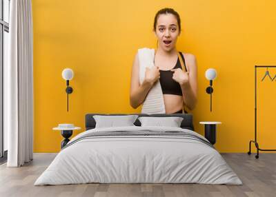 Young fitness girl surprised, feels successful and prosperous Wall mural