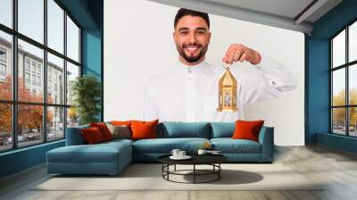 Young handsome arab man holding a lamp Wall mural