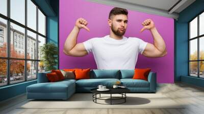 Young handsome caucasian man feels proud and self confident, example to follow. Wall mural