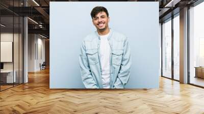 Young hispanic cool man happy, smiling and cheerful. Wall mural