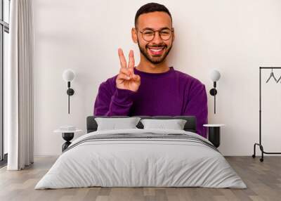 Young hispanic man isolated on white background showing number two with fingers. Wall mural