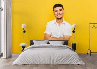 Young hispanic man laughing and having fun. Wall mural