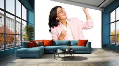 Young Indian business woman wearing a pink suit isolated raising fist after a victory, winner concept. Wall mural