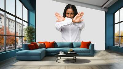 Young Indian woman cut out isolated on white background doing a denial gesture Wall mural