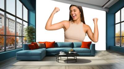 Young Indian woman isolated cutout removal background raising fist after a victory, winner concept. Wall mural