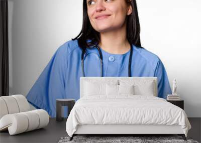 Young nurse woman isolated dreaming of achieving goals and purposes Wall mural