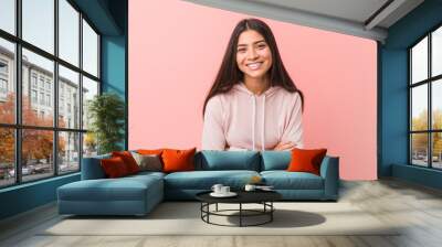 Young pretty arab woman wearing a casual sport look laughing and having fun. Wall mural