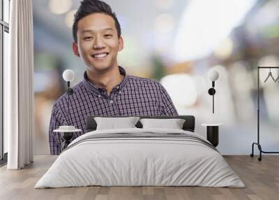 Handsome young asian man smiling wearing a plaid shirt Wall mural