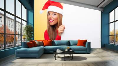 portrait of a beautiful young woman at Christmas holding a white banner Wall mural