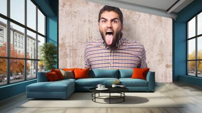 portrait of a young man showing his tongue Wall mural