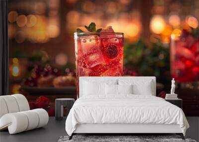 a glass of red drink with ice and berries.

 Wall mural