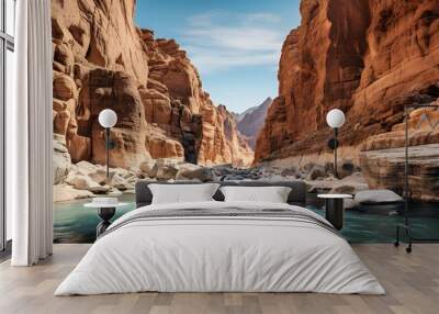 A serene canyon filled with clear water and scattered rocks. Wall mural