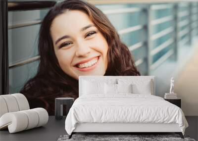 cute brunette woman laughing in the street Wall mural