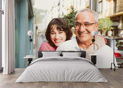 Portrait of happy father and daughter embracing on the street Wall mural