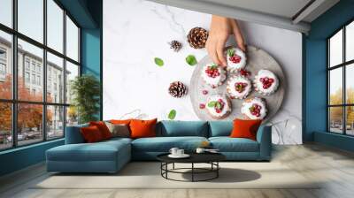 Woman picking a delicious Christmas dessert Wall mural