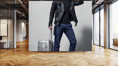 Elegant young handsome man with luggage. Studio fashion portrait. Wall mural