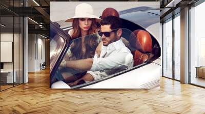 Sexy couple in the car. Luxury life. Wall mural