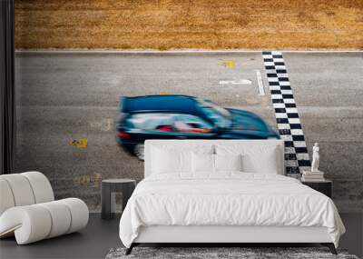 Black car crosses the finish line on the race track Wall mural