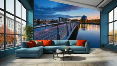 Urban Elegance Contemporary Pedestrian Bridge Over Tranquil River at Dusk Wall mural