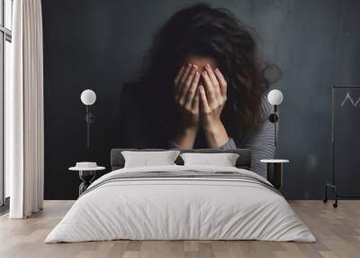 Depressed young woman covering her face with her hands. Young Woman Coping with Distress by Covering Her Face. mental health concept. Wall mural