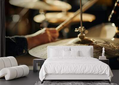 Drummer playing cymbals and drums in dimly lit studio, focus on musical passion and rhythm Wall mural