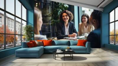 Portrait of Young business woman having a discussion with her team in modern office, collaboration and teamwork in business concept Wall mural