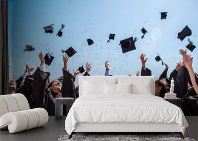 Students throwing graduation hats in the air celebrating. education concept with students celebrate success with hats and certificates Wall mural