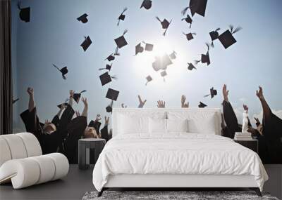 Students throwing graduation hats in the air celebrating. education concept with students celebrate success with hats and certificates Wall mural