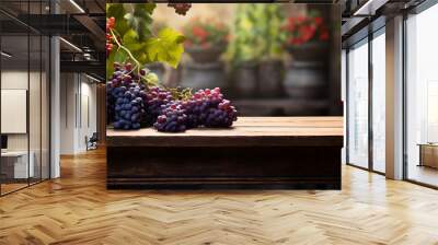 Vineyard grapes on a wooden table with nature blurred background. Fresh grapes on wooden table overlooking vineyard at sunset Wall mural