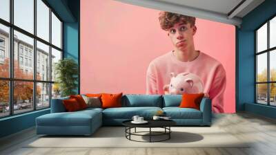 Student holding a piggy bank  concerned expression Wall mural